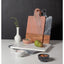Set of marble and wooden cutting boards on a white surface with a dark background