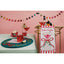 Table setting with drinks and a decorative towel on a pink wall background