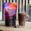 GNAW Hot Chocolate Flakes packaging with a glass of hot chocolate on a wooden surface.
