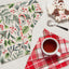 Christmas-themed table setting with a mug, plaid napkin, and decorative items.
