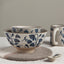 Ceramic bowls with blue floral patterns on a neutral background