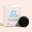Scalp care conditioner bar with packaging labeled 'good juju' on a light pink background