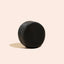 Black wooden block on a beige background