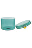 Turquoise glass container with a yellow ball inside on a white background