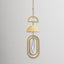 Decorative hanging gold wind chime with crystal on a light gray background