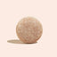 Round, textured object on a beige background