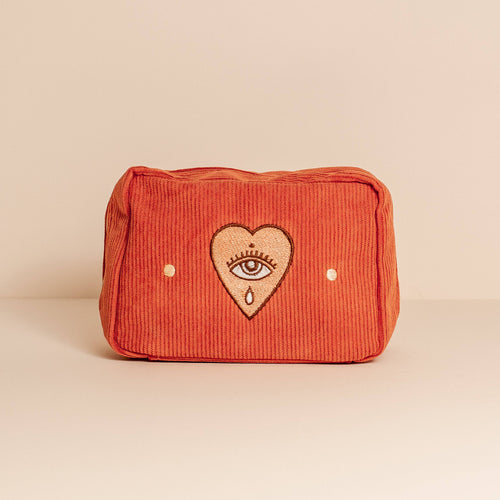 makeup bag in rust with a eye and heart embroidery 