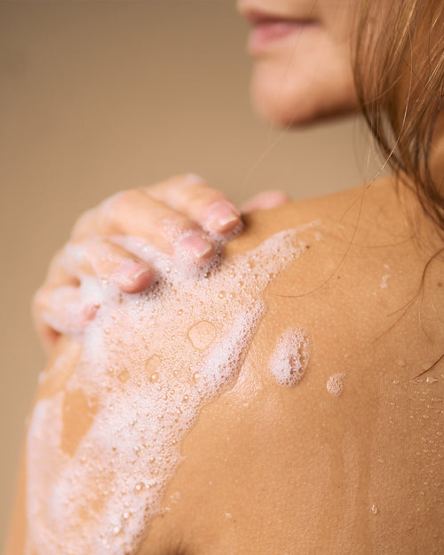 aide soap foaming on persons shoulder