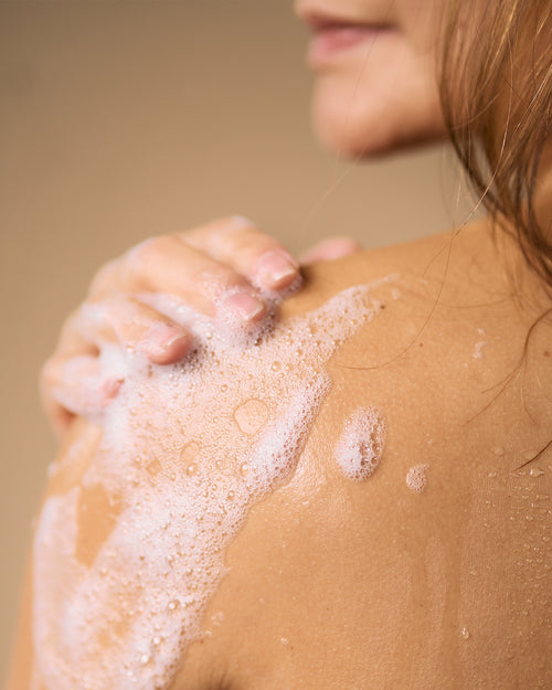 soap bubbles on persons shoulder